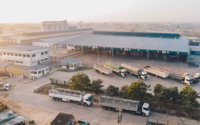 aerial-view-factory-trucks-parked-near-warehouse-daytime